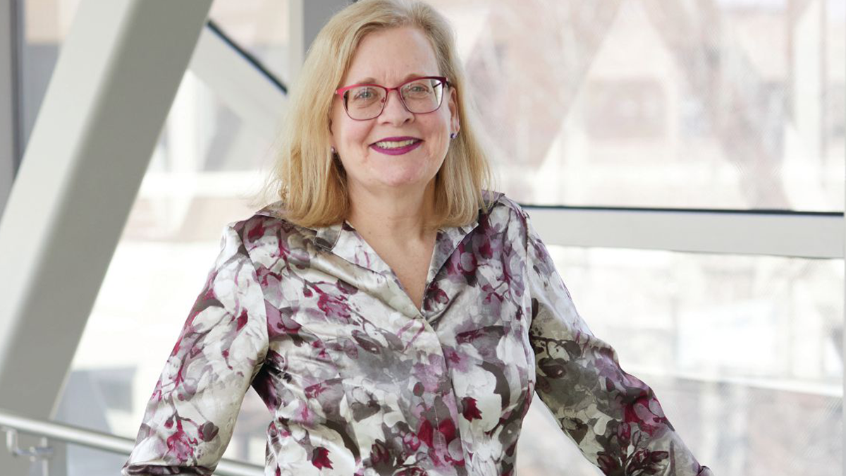 Physician Susan Thompson standing and smiling